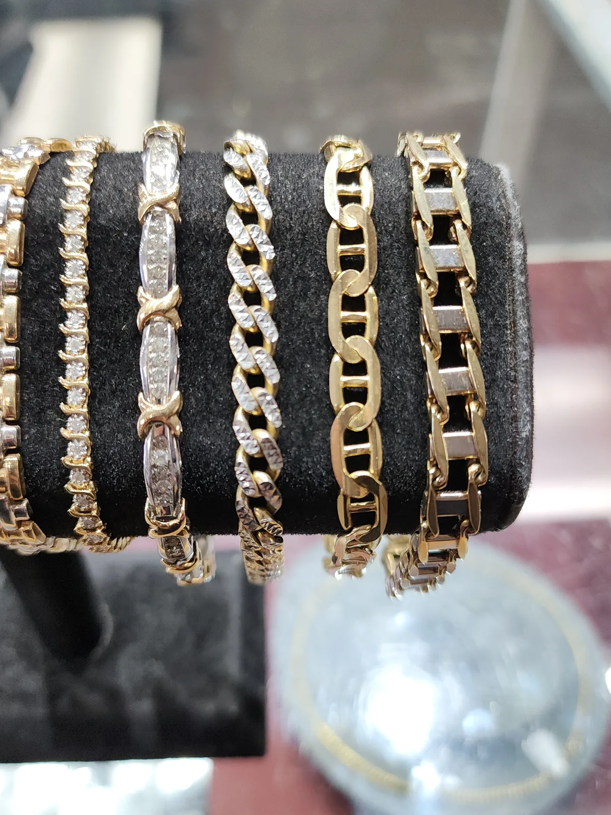 Gold and diamond bracelets on a display stand