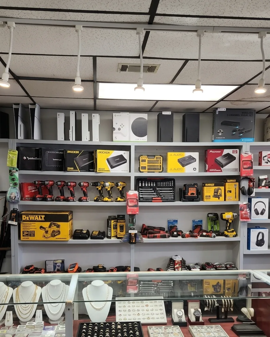 Gaming consoles, jewelry, and tools on display